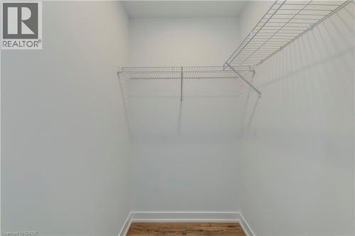 Walk in closet featuring wood finished floors - 770 Whitlock Avenue Unit# 606, Milton, ON - Indoor Photo Showing Other Room