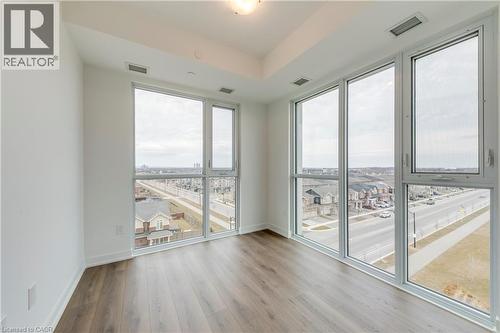 Unfurnished room with light wood-type flooring and expansive windows - 770 Whitlock Avenue Unit# 606, Milton, ON - Indoor Photo Showing Other Room