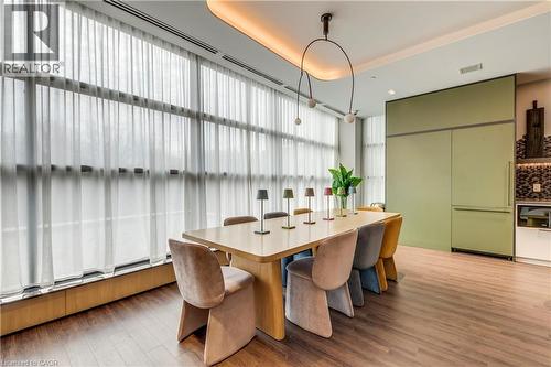 Dining area featuring light wood-type flooring and a raised ceiling - 770 Whitlock Avenue Unit# 606, Milton, ON - Indoor