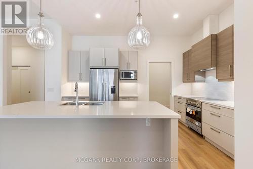 Pantry leading to laundry - 507 - 77 Yates Street, St. Catharines (Downtown), ON - Indoor Photo Showing Kitchen With Stainless Steel Kitchen With Double Sink With Upgraded Kitchen
