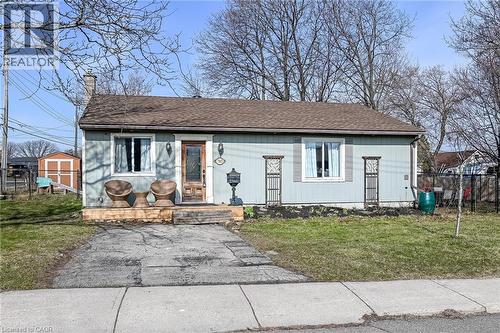 View of front of property featuring a chimney and a shingled roof - 703 Dunn Avenue, Hamilton, ON - Outdoor