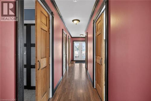 Corridor with ornamental molding, dark wood finished floors, and a barn door - 703 Dunn Avenue, Hamilton, ON - Indoor Photo Showing Other Room