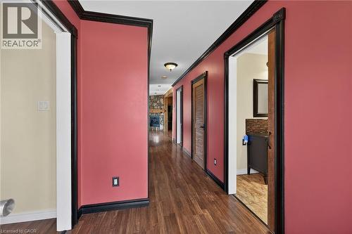 Corridor featuring crown molding and dark wood finished floors - 703 Dunn Avenue, Hamilton, ON - Indoor Photo Showing Other Room