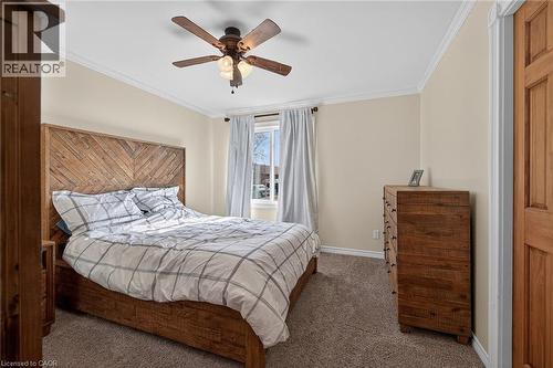 Bedroom with ornamental molding, ceiling fan, and dark carpet - 703 Dunn Avenue, Hamilton, ON - Indoor Photo Showing Bedroom
