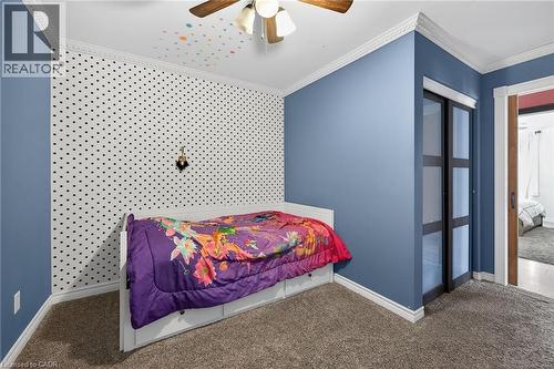 Carpeted bedroom featuring ornamental molding, ceiling fan, and a closet - 703 Dunn Avenue, Hamilton, ON - Indoor Photo Showing Bedroom