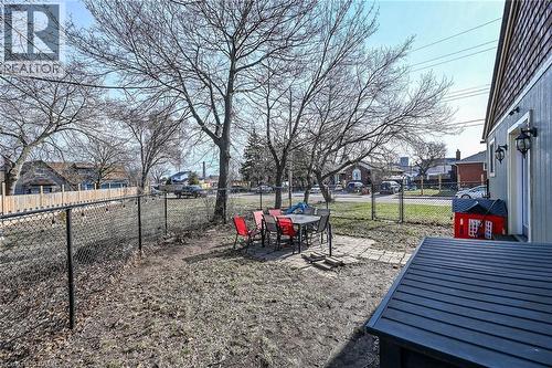 Fenced backyard featuring a patio area, a residential view, and outdoor dining area - 703 Dunn Avenue, Hamilton, ON - Outdoor