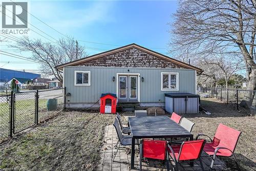 Back of property with a fenced backyard, a gate, french doors, outdoor dining space, and a patio area - 703 Dunn Avenue, Hamilton, ON - Outdoor