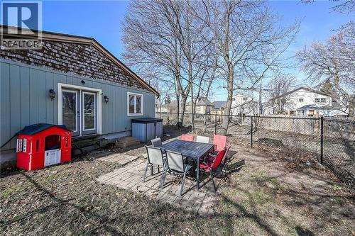 Fenced backyard featuring a patio, entry steps, outdoor dining area, a residential view, and french doors - 703 Dunn Avenue, Hamilton, ON - Outdoor