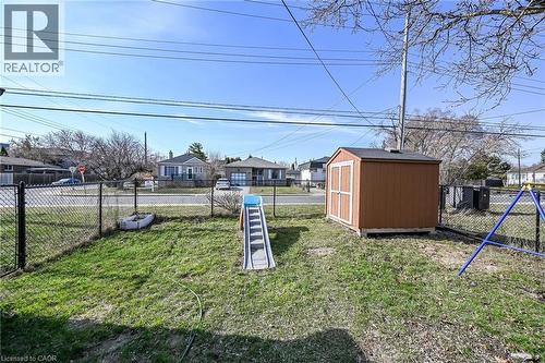 Fenced backyard featuring a residential view and a storage unit - 703 Dunn Avenue, Hamilton, ON - Outdoor