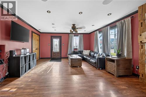 Living area with ceiling fan, dark wood-style floors, ornamental molding, and recessed lighting - 703 Dunn Avenue, Hamilton, ON - Indoor