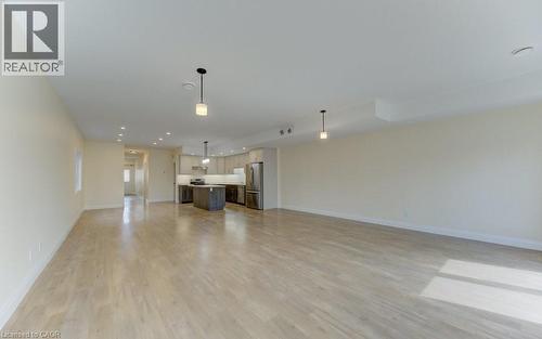 Unfurnished living room featuring light wood-type flooring and recessed lighting - 113 Walter Street, Kitchener, ON - Indoor