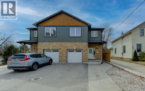 View of front of home featuring brick siding, driveway, and a garage - 113 Walter Street, Kitchener, ON - Outdoor