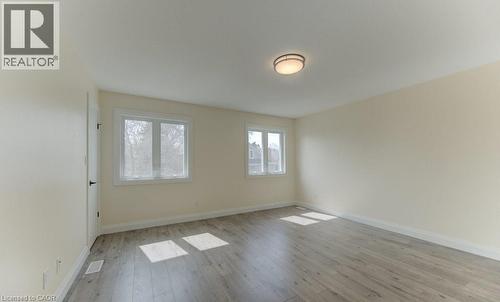 Unfurnished room featuring baseboards and light wood finished floors - 113 Walter Street, Kitchener, ON - Indoor Photo Showing Other Room
