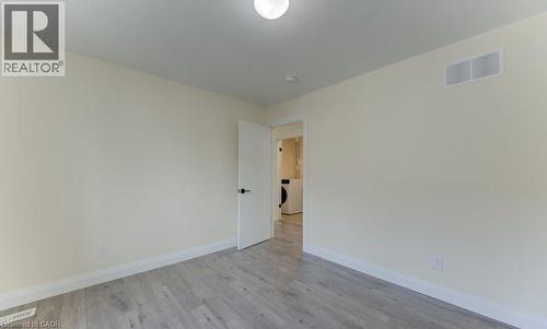 Spare room featuring light wood-style floors and washer / clothes dryer - 113 Walter Street, Kitchener, ON - Indoor Photo Showing Other Room