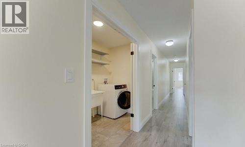 Laundry area with washer / clothes dryer and light wood-style flooring - 113 Walter Street, Kitchener, ON - Indoor Photo Showing Laundry Room