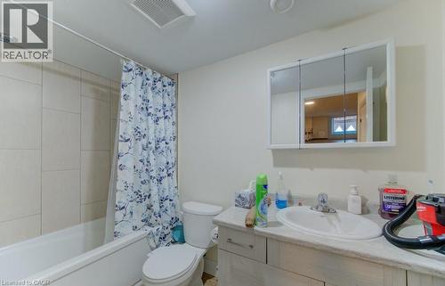 Bathroom featuring vanity and shower / bath combo with shower curtain - 113 Walter Street, Kitchener, ON - Indoor Photo Showing Bathroom