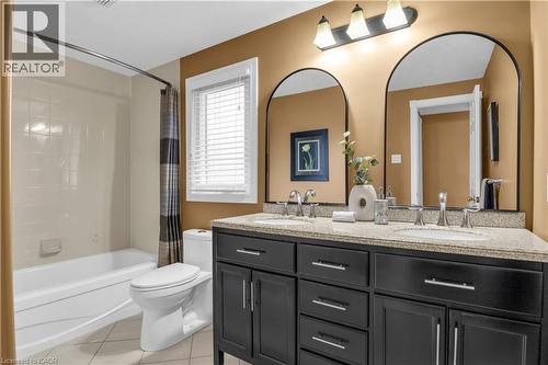 Full bathroom with double vanity, light tile patterned floors, and shower / tub combo with curtain - 228 Michener Crescent, Kitchener, ON - Indoor Photo Showing Bathroom