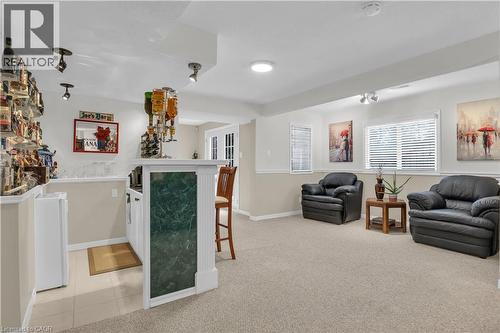 Indoor bar featuring light colored carpet and baseboards - 228 Michener Crescent, Kitchener, ON - Indoor