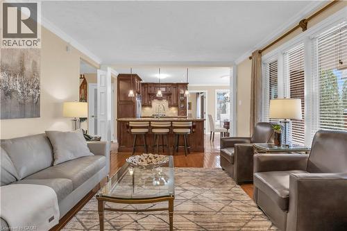 Living area with crown molding and light wood-style flooring - 228 Michener Crescent, Kitchener, ON - Indoor Photo Showing Living Room
