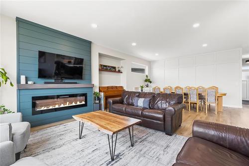 23 Murano Cove, Steinbach, MB - Indoor Photo Showing Living Room With Fireplace