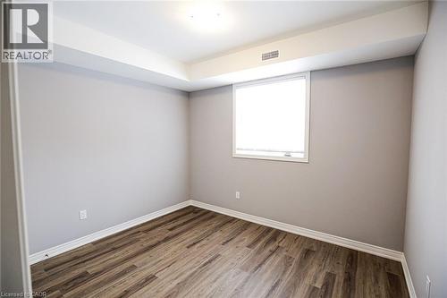 Empty room featuring dark wood-type flooring and baseboards - 40 Pietz Avenue, Welland, ON - Indoor Photo Showing Other Room