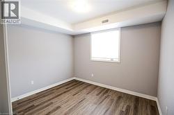 Empty room featuring dark wood-type flooring and baseboards - 