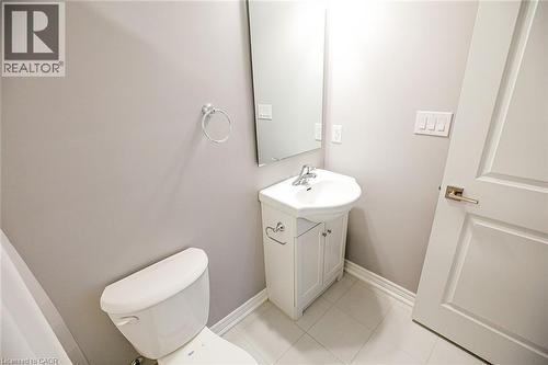 Half bathroom featuring vanity and light tile patterned flooring - 40 Pietz Avenue, Welland, ON - Indoor Photo Showing Bathroom