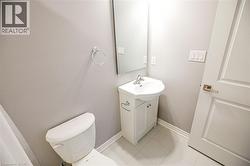 Half bathroom featuring vanity and light tile patterned flooring - 