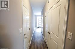 Hallway featuring dark wood-style floors - 