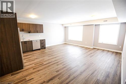 Kitchen with light countertops, light wood finished floors, dark wood finish cabinets, dishwasher, and open floor plan - 40 Pietz Avenue, Welland, ON - Indoor
