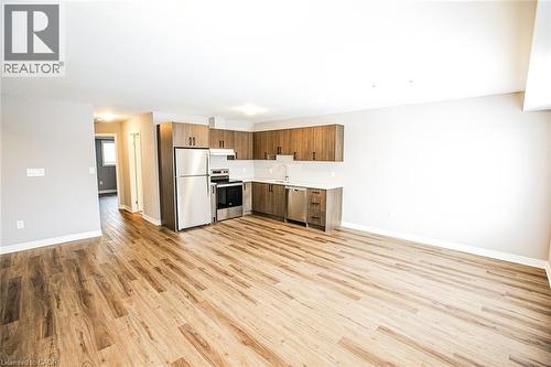 Kitchen with light countertops, stainless steel appliances, open floor plan, and light wood-style flooring - 40 Pietz Avenue, Welland, ON - Indoor Photo Showing Kitchen