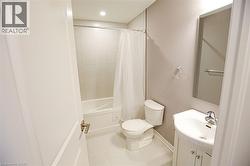 Full bath featuring vanity, shower / tub combo with curtain, light tile patterned floors, and recessed lighting - 