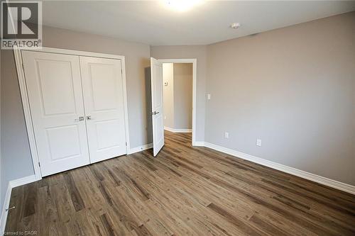 Unfurnished bedroom with a closet and dark wood-style flooring - 40 Pietz Avenue, Welland, ON - Indoor Photo Showing Other Room