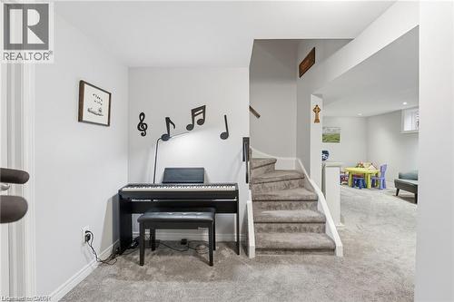 Staircase with carpet flooring and baseboards - 668 Tomahawk Crescent, Ancaster, ON - Indoor Photo Showing Other Room
