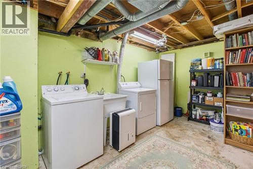 Laundry area featuring washing machine and clothes dryer and concrete floors - 668 Tomahawk Crescent, Ancaster, ON - Indoor Photo Showing Laundry Room