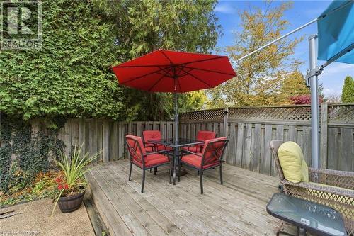 Wooden terrace with outdoor dining space and a fenced backyard - 668 Tomahawk Crescent, Ancaster, ON - Outdoor With Deck Patio Veranda