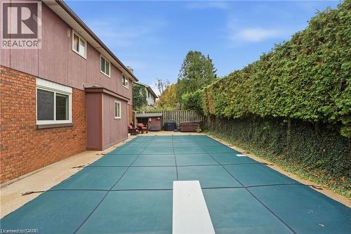 View of swimming pool featuring patio surround, a fenced backyard, and a diving board - 668 Tomahawk Crescent, Ancaster, ON - Outdoor