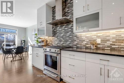 Stainless steel hood fan and gas stove. - 250 Richardson Avenue, Ottawa, ON - Indoor Photo Showing Kitchen With Upgraded Kitchen