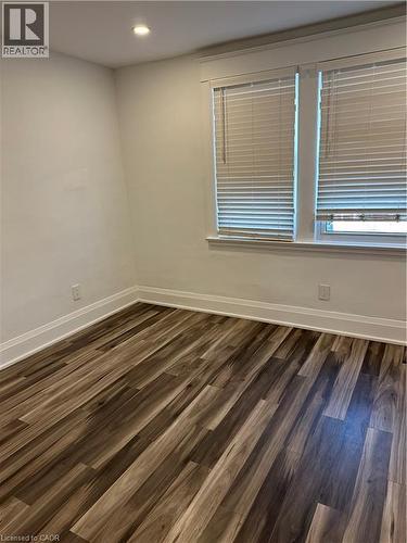 Unfurnished room with dark hardwood / wood-style floors - 1090 Cannon Street E, Hamilton, ON - Indoor Photo Showing Other Room