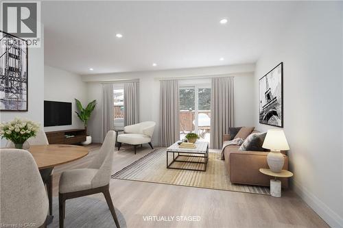 Living room with light wood-style floors, healthy amount of natural light, and recessed lighting - 27 Queenston Drive, Kitchener, ON - Indoor