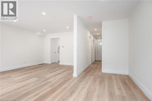Empty room with light wood-style floors and recessed lighting - 27 Queenston Drive, Kitchener, ON - Indoor Photo Showing Other Room