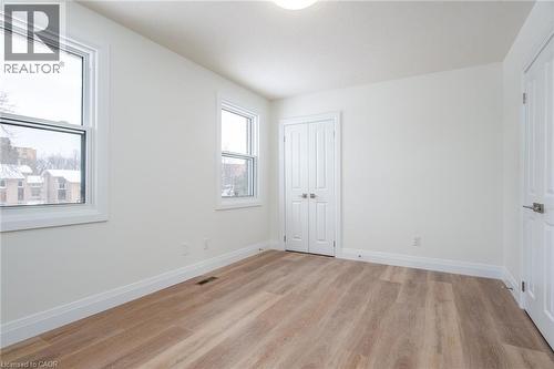 Unfurnished bedroom featuring light wood-type flooring and a closet - 27 Queenston Drive, Kitchener, ON - Indoor Photo Showing Other Room