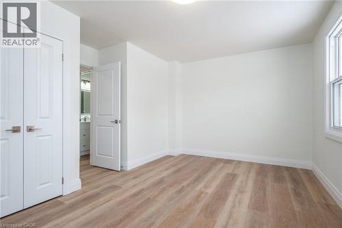Unfurnished bedroom featuring light wood-style flooring and a closet - 27 Queenston Drive, Kitchener, ON - Indoor Photo Showing Other Room