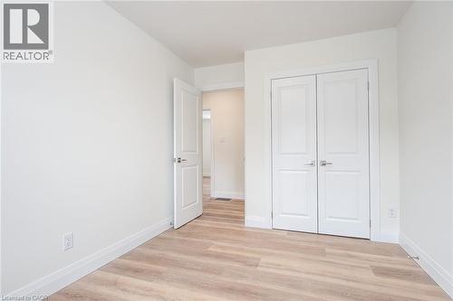 Unfurnished bedroom with light wood-style floors and a closet - 27 Queenston Drive, Kitchener, ON - Indoor Photo Showing Other Room