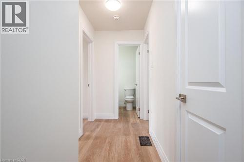Corridor with baseboards and light wood-type flooring - 27 Queenston Drive, Kitchener, ON - Indoor Photo Showing Other Room