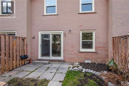 Rear view of house featuring brick siding and a patio - 27 Queenston Drive, Kitchener, ON - Outdoor With Exterior