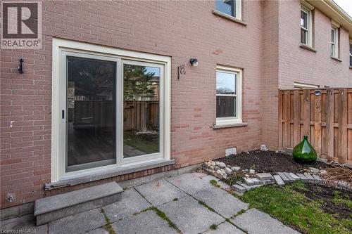 Doorway to property featuring brick siding and a patio - 27 Queenston Drive, Kitchener, ON - Outdoor With Exterior
