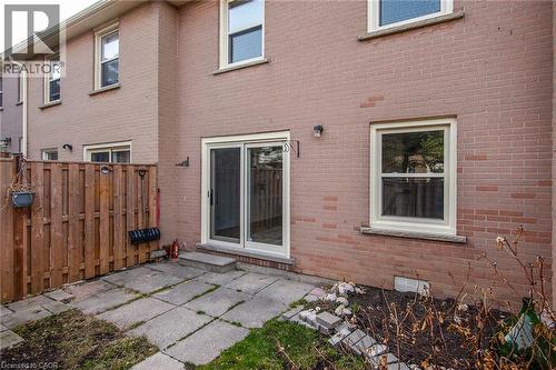 Rear view of property featuring a patio and brick siding - 27 Queenston Drive, Kitchener, ON - Outdoor With Deck Patio Veranda With Exterior