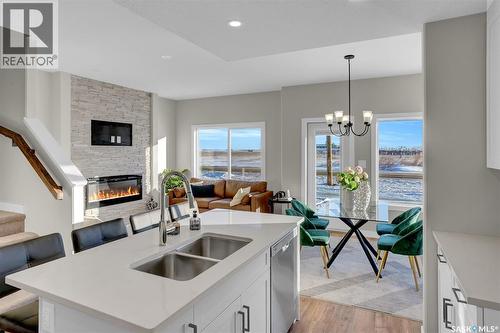 230 Kostiuk Crescent, Saskatoon, SK - Indoor Photo Showing Kitchen With Fireplace With Double Sink