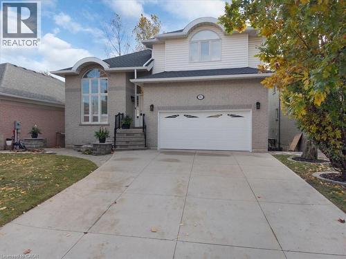 View of front of home featuring concrete driveway, a garage, a front yard, and roof with shingles - 90 Westlawn Drive, Hamilton, ON - Outdoor With Facade